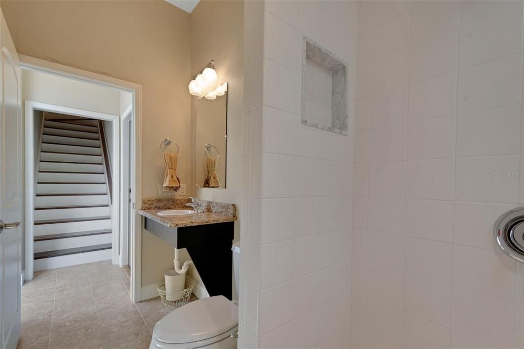 The 2nd garage /guest house has 2 full bathrooms. this is the full bath in the Air conditioned garage, the stairs in the rear of the picture lead to the upstairs guest suite.