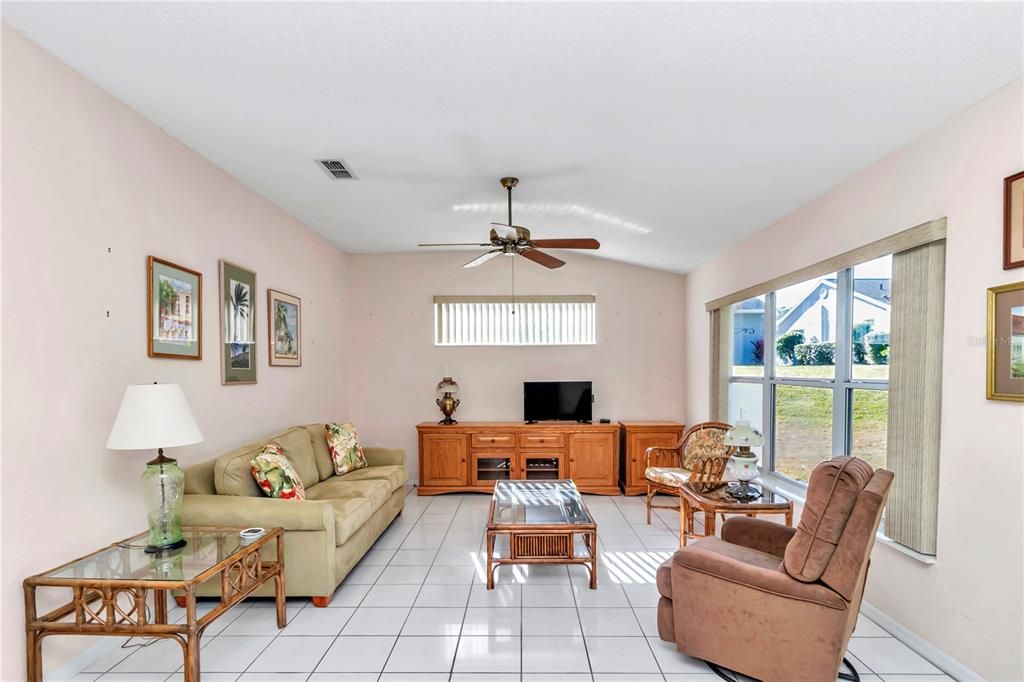 High ceilings in living room with plenty of windows