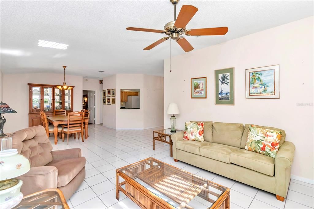 Living room looking toward dining and kitchen with pass through window