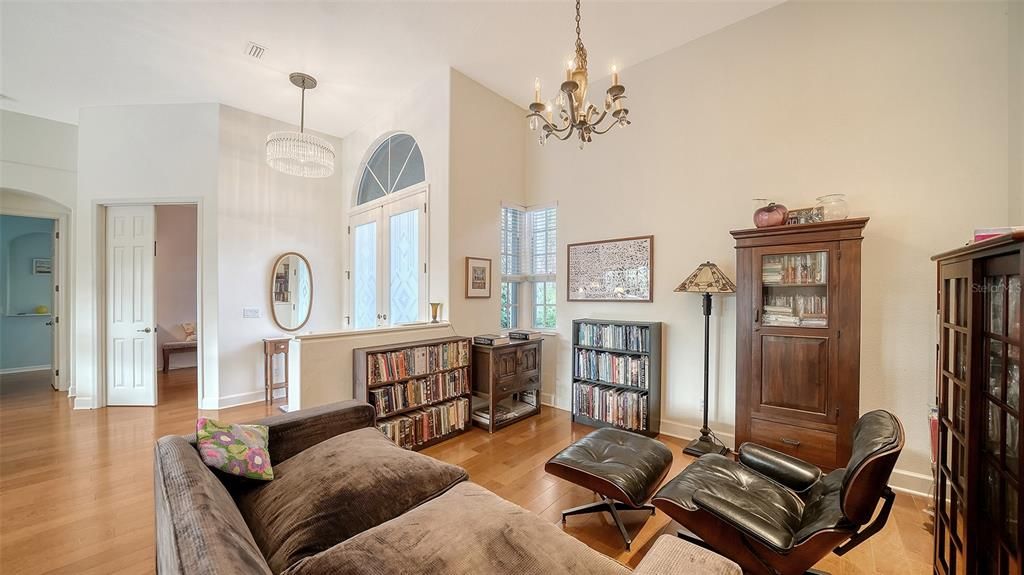 Formal dining room in the foreground, double doors to the office in the background.