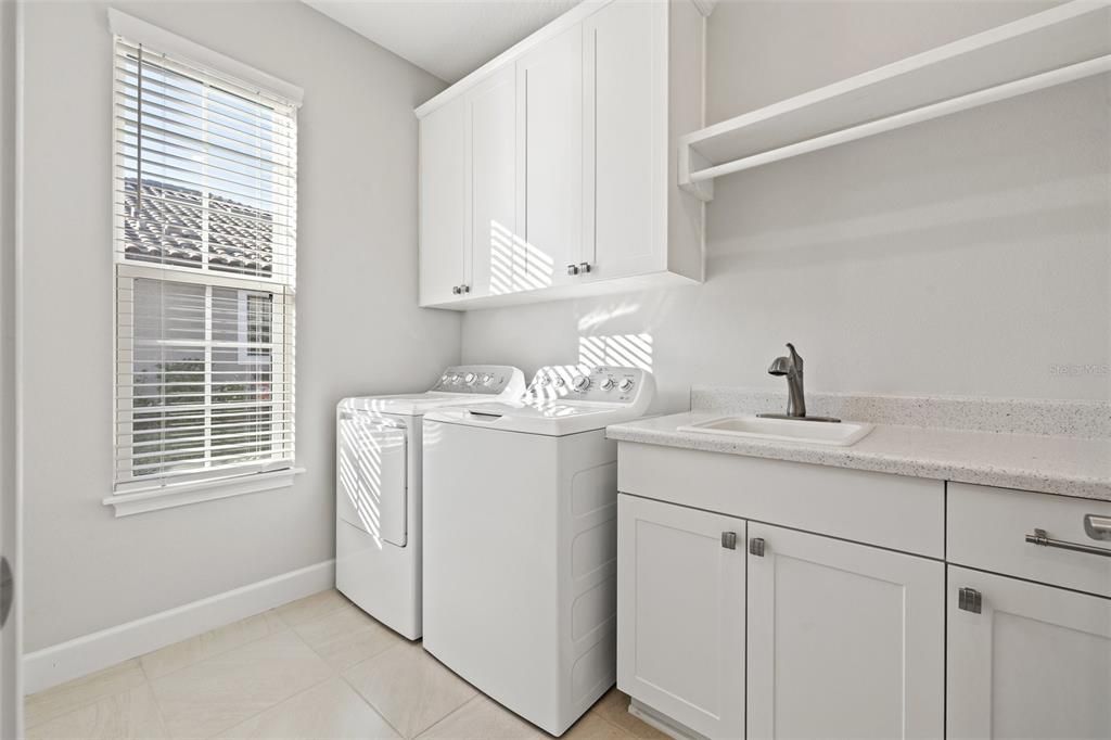 Laundry room with custom cabinets & utility sink