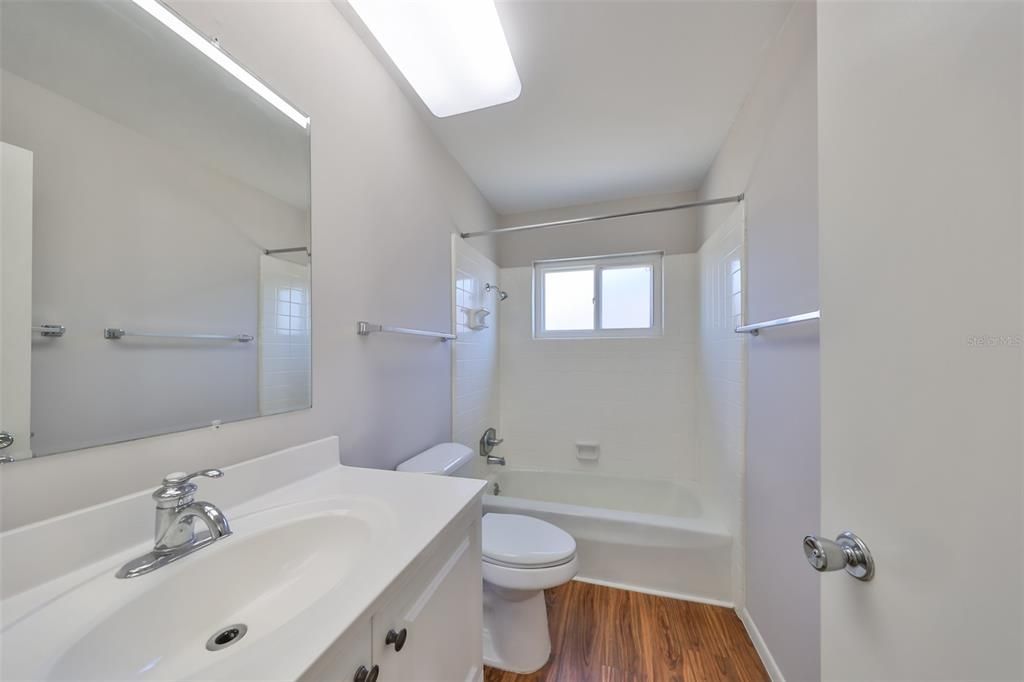 Bathroom 2, laminate flooring, elongated commode, newer vanity