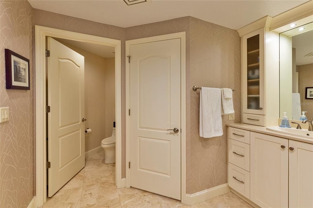 Water closet, additional walk-in closet giving you three walk-ins and 2nd vanity in primary.