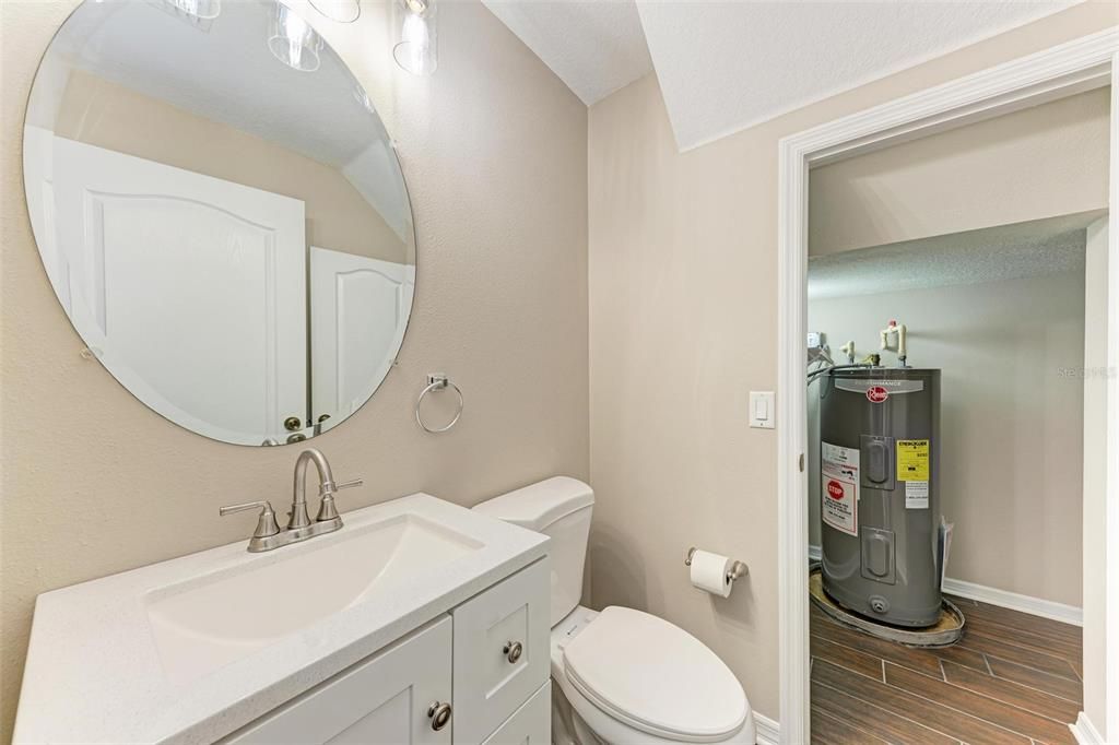 Half Bath located on 1st floor with access to a spacious closet that wraps around to under the stairs