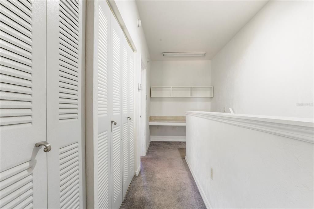 Upstairs hallway with study or crafting nook. Some residents have converted to a closed storage closet or built-in shelving.