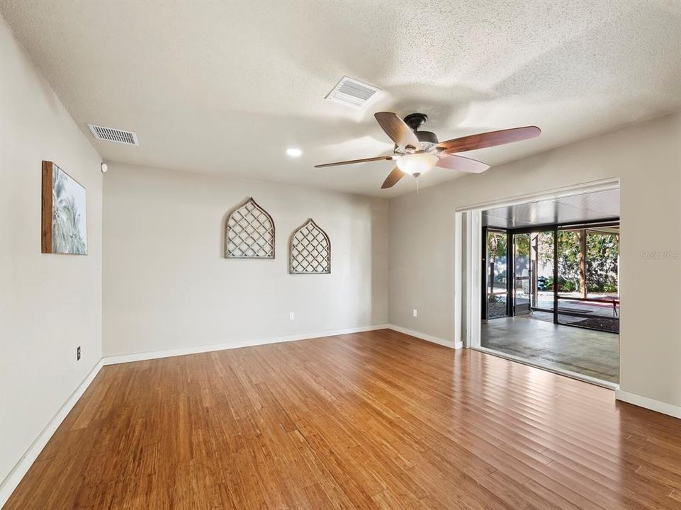 The large Primary bedroom in the back of the home features storm rated sliders that open completely to the screened in porch and then out to that amazing, large pergola.