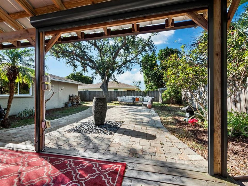 From the pergola, you look across the water feature to the rest of this tremendous back yard!