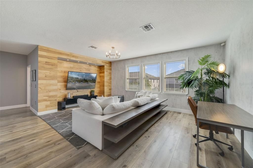 At the top of the stairs additional flexible living space awaits in the BONUS/LOFT, a bright and comfortable place to gather the family with custom accent walls and a built-in nook for your TV.