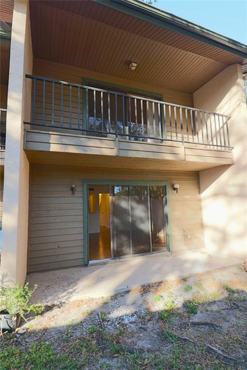 Exterior back, showing patio off living room, and balcony off guest bedroom.