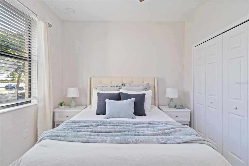 Guest bedroom features built-in closet and upgraded ceiling fan