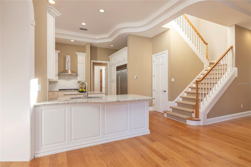 Door by back stairway opens to a walk in pantry