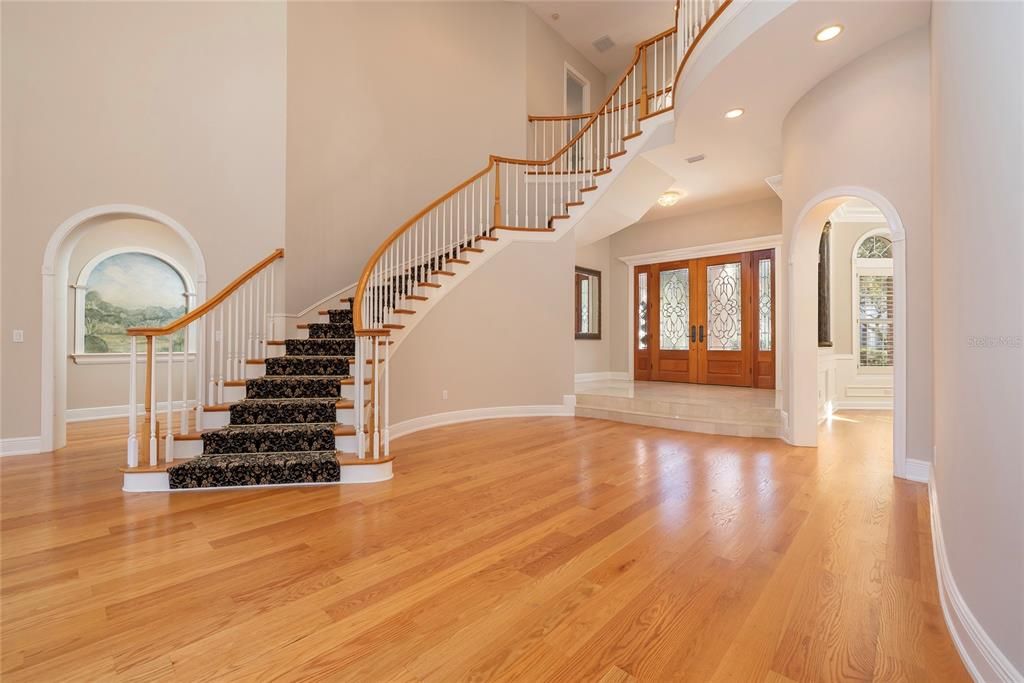 Front door opens to reveal the living room and dining room. The alcove fits a baby grand piano.