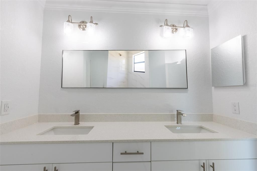 Double sinks in the master bedroom, with neutral colors for your own touch.