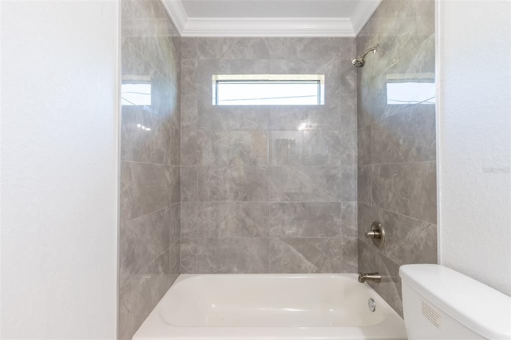 tile to the ceiling and tub in 2nd bathroom.