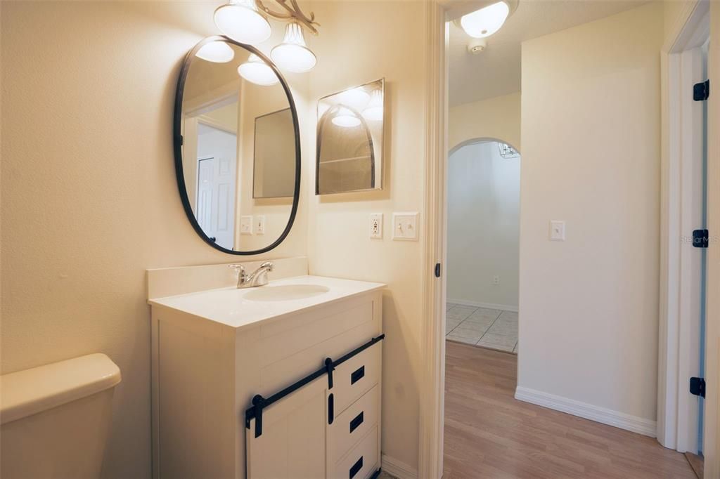 Guest bath vanity towards entrance.