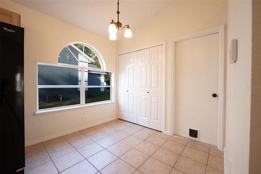 Eat-in area of kitchen towards large pantry, laundry room, and garage.