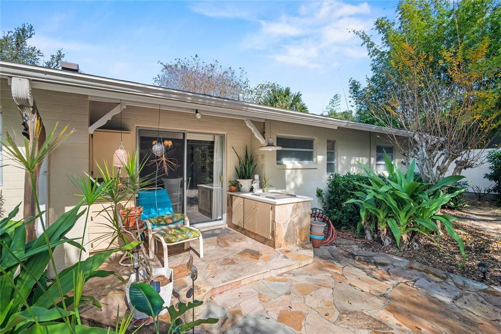 Spacious backyard with a covered area for an outdoor kitchen