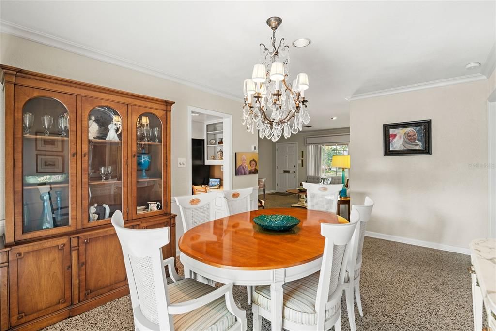 Dining room with chair railing and sliding glass doors leading to the beautiful backyard