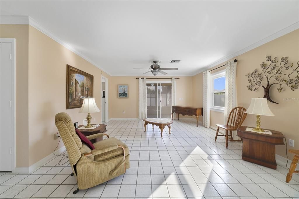 There are easy care TILE FLOORS throughout the open living and dining areas that continue into the kitchen and out onto the ENCLOSED LANAI.