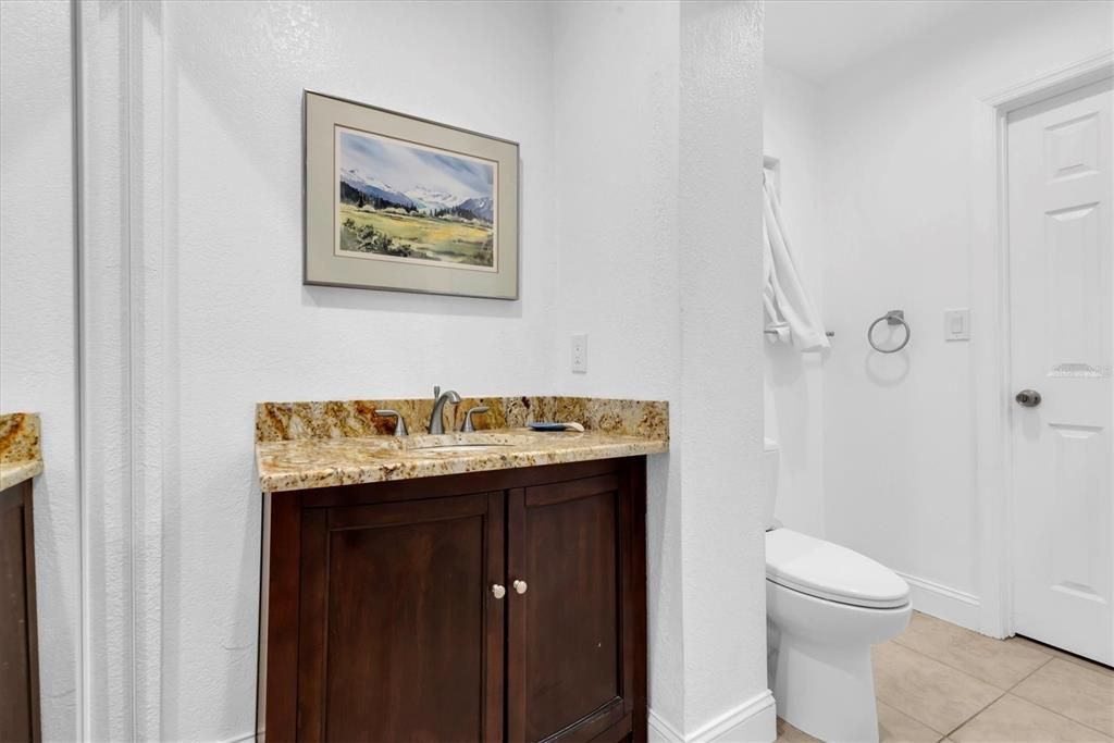 Full bathroom, vanity has granite counter tops, good size closet for ample storage and second door into the Primary suite.