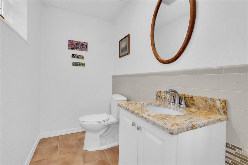 Recently updated Half bath on office side.  Vanity has granite counter tops.