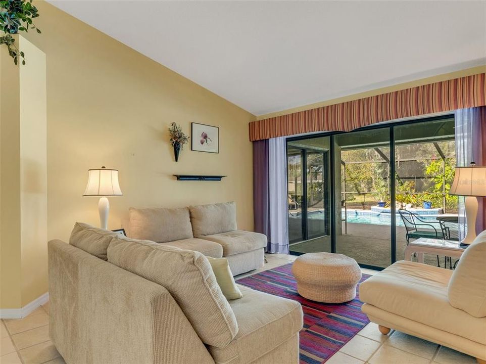 Immediately upon entering you are greeted with a view of the pool and lush landscaping beyond.