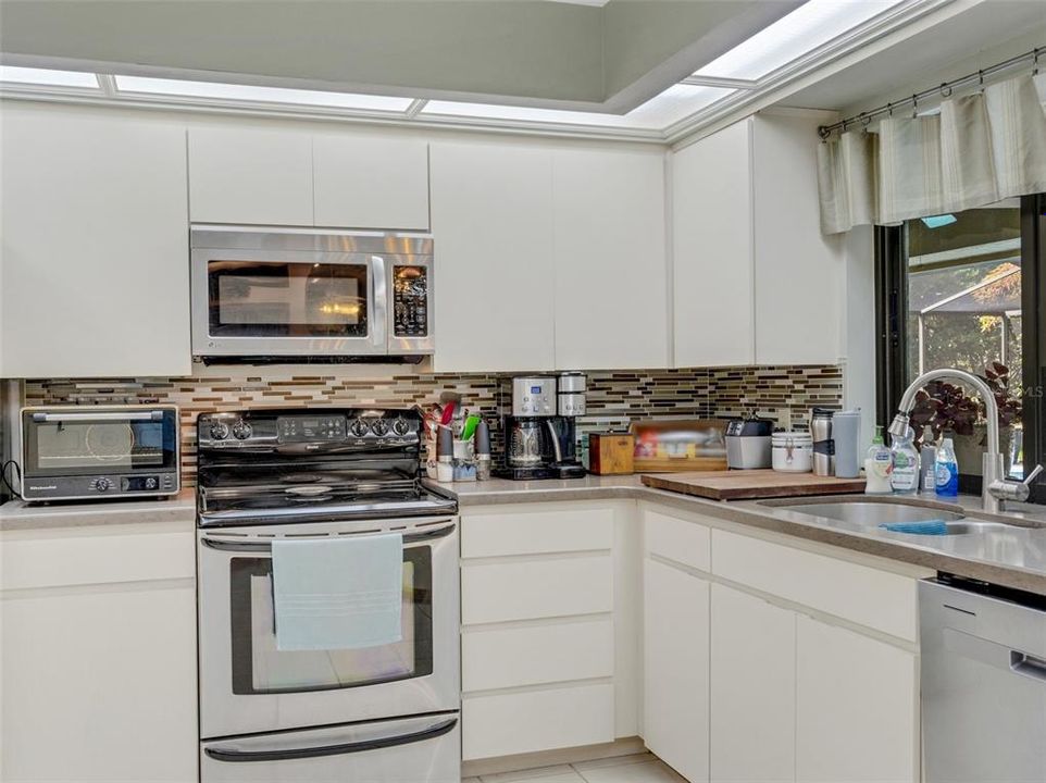 Newer appliances and tile backsplash