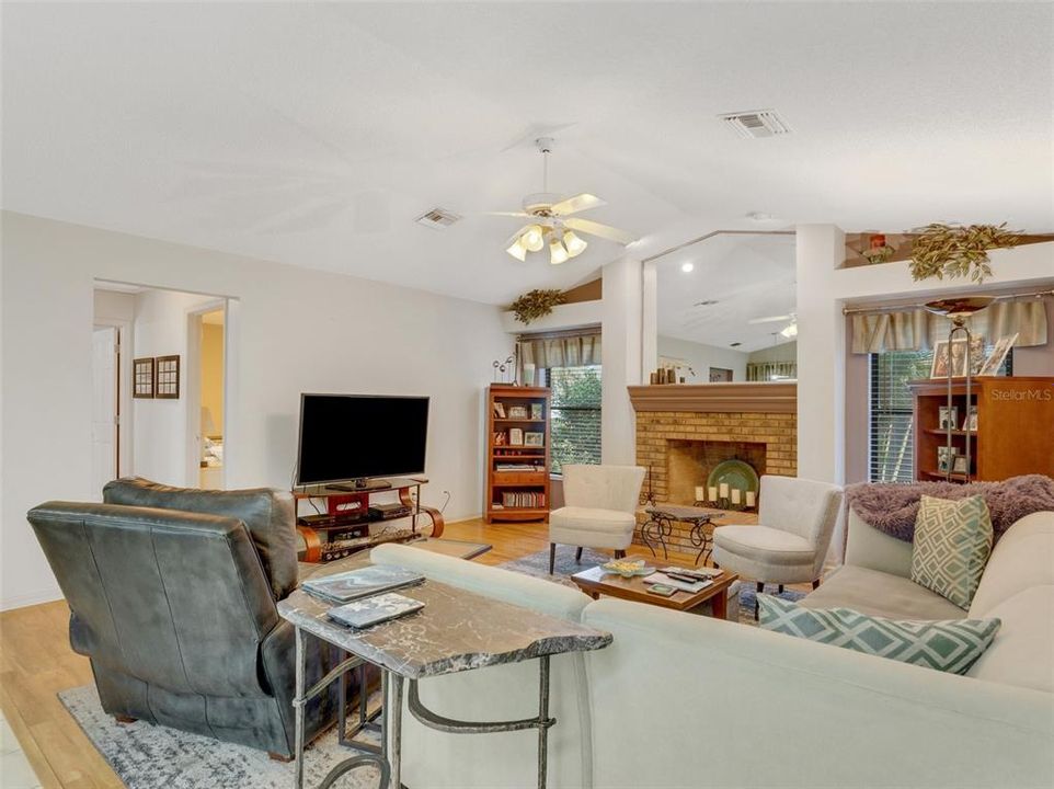 A vaulted ceiling plus beautiful wood laminate flooring.