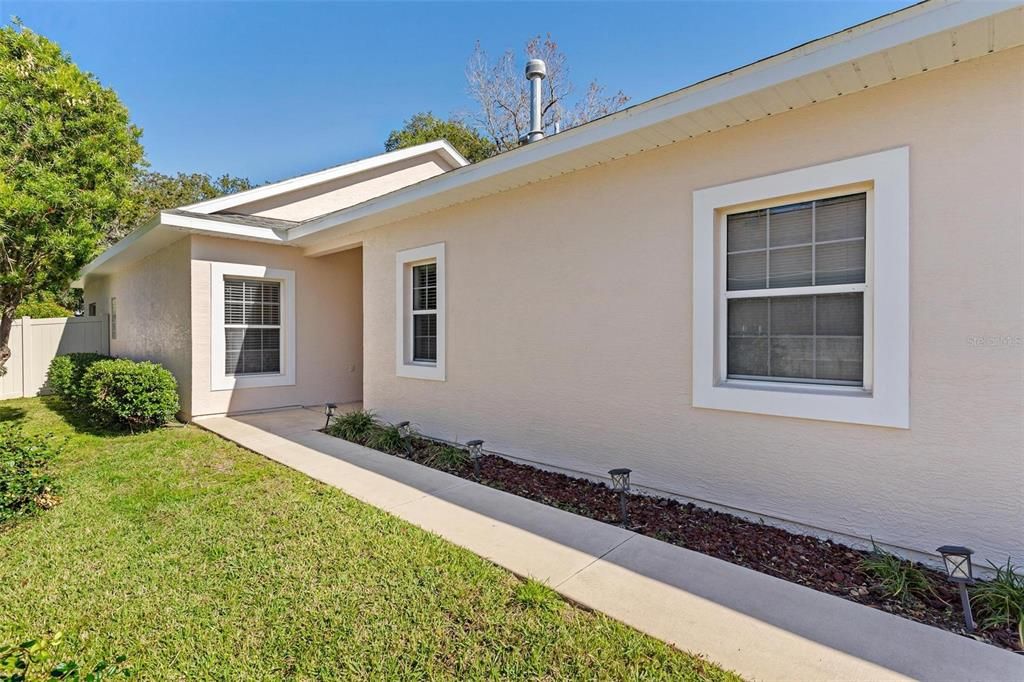 Exterior of home with sidewalk leading to the front entry