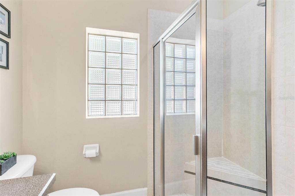 Primary bathroom features shower and walk in closet.