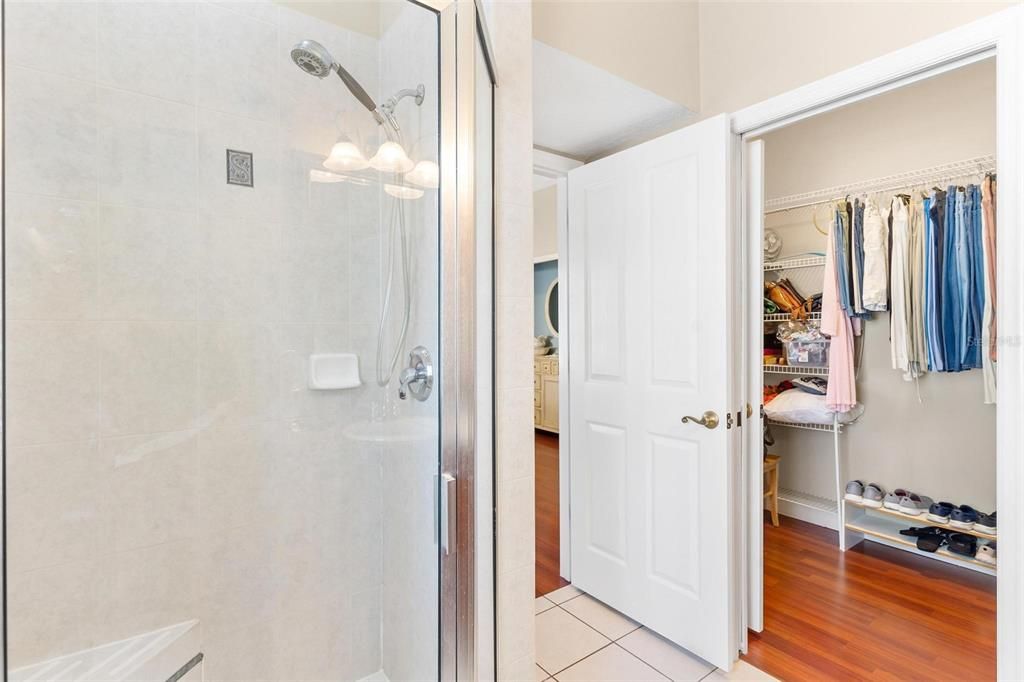 Primary bathroom features shower and walk in closet.