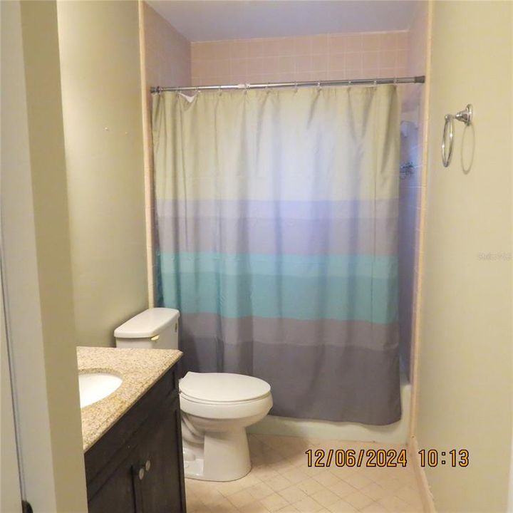 Guest bathroom with tub shower combo