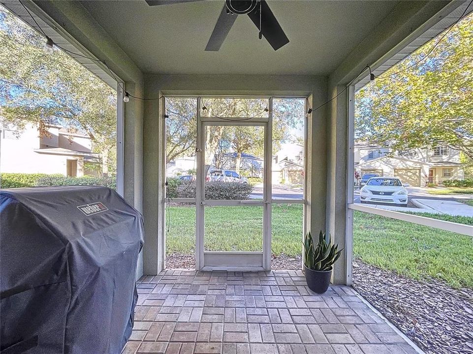 Screened Private Lanai with brick pavers and ceiling fan.