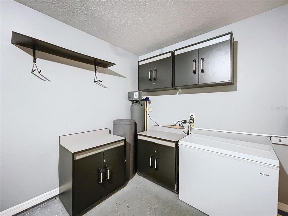 Space in Garage with Cabinets & Shelves