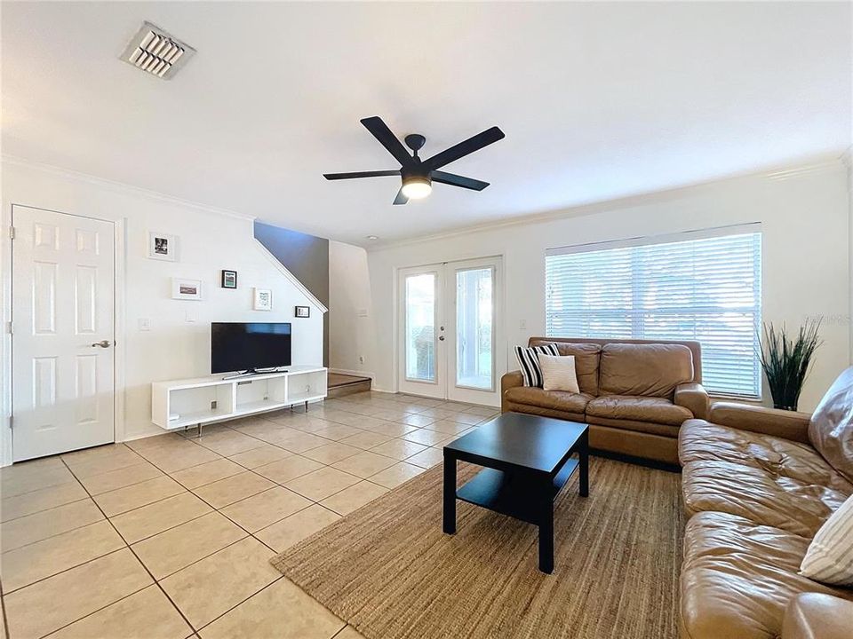 Spacious Living room with high ceilings and French doors leading to lanai