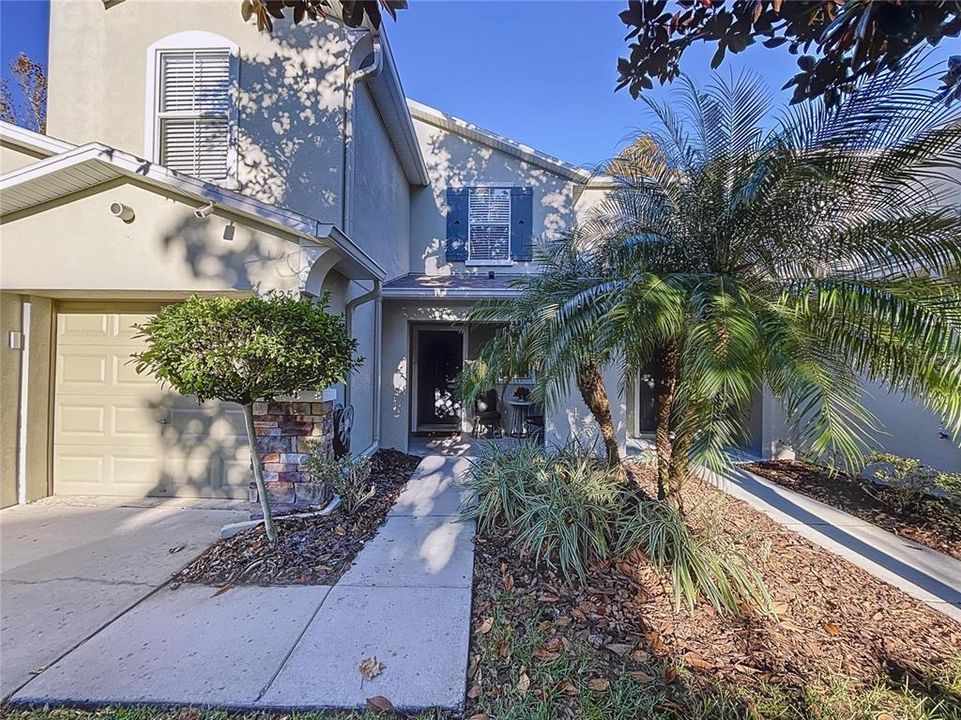 Inviting entrance with mature landscaping and spacious front porch.