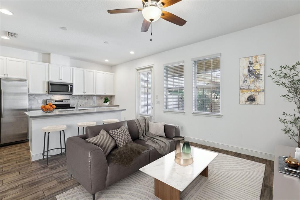 This BEAUTIFUL TOWNHOME is the EPITOME of AFFORDABLE LUXURY. LUXURIOUS UPGRADES INCLUDE: Porcelain Wood Look Tile throughout the downstairs, complemented by fresh interior paint, and a large kitchen that includes an oversized island, Corian Countertops, White Cabinets, Stainless Steel Appliances and Tile Backsplash!