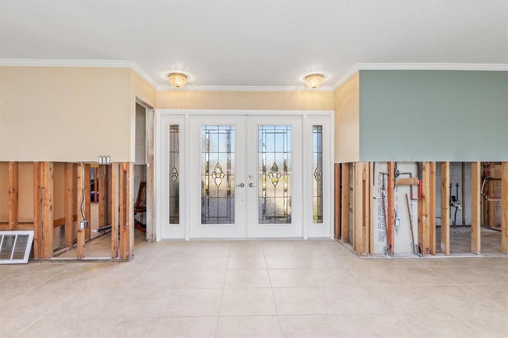 Standing in great room looking at front double doors. Handy coat closet tucked in beside front door on left.