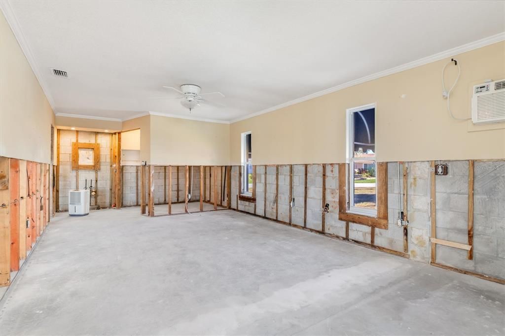 Primary bedroom is 33 feet long. Standing in front of one walk in closet looking at other end.  Vanity area at end and 2nd walk in closet on right.