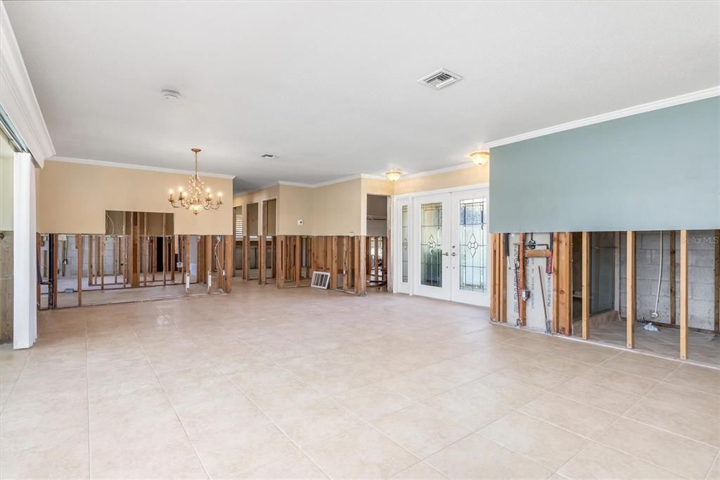 Standing at Primary bedroom door looking at great room, entrance and dining.