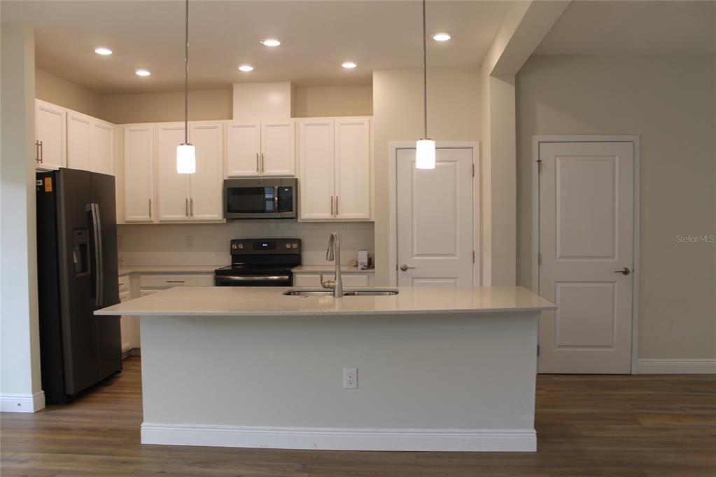 Kitchen Island seating with down stairs 1/2 bathroom