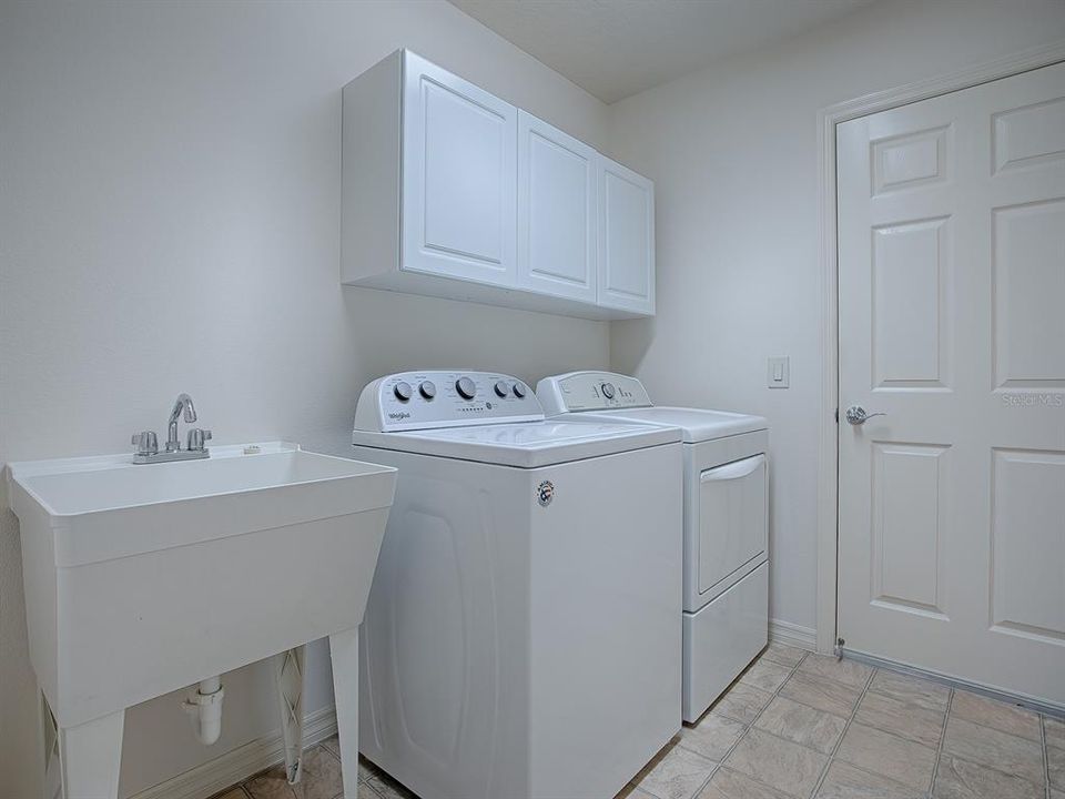 INSDE LAUNDRY ROOM WITH SINK, CABINETS AND WASHER AND DRYER THAT DO CONVEY WITH THE HOME.