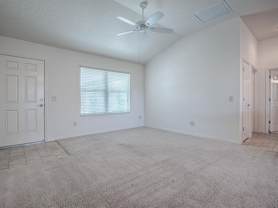 LIVING ROOM WITH VAULTED CEILINGS.