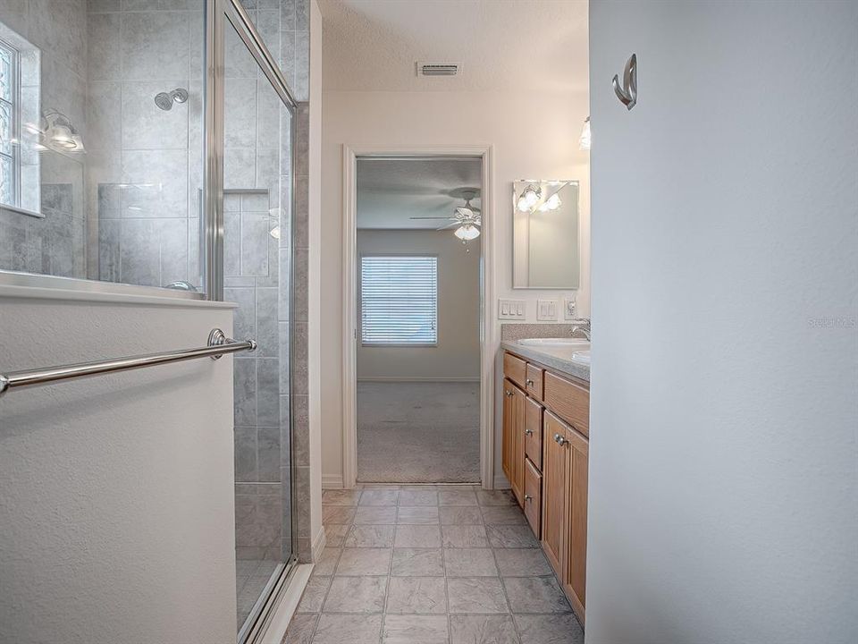 PRIMARY BATH - SHOWER WITH GLASS ENCLOSURE. VINYL FLOORING.