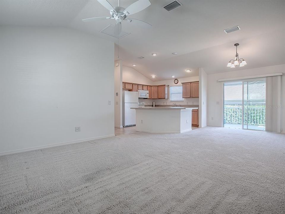 OPEN FLOOR PLAN WITH CARPET FLOORING IN THE MAIN LIVING AREA AND BEDROOMS.