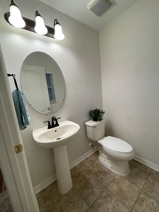 DOWNSTAIRS POWDER ROOM OFF OF THE FOYER