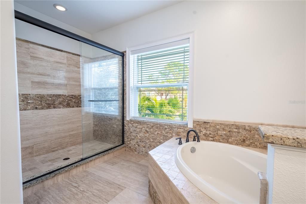 The primary ensuite features a garden tub and a large walk-in shower.