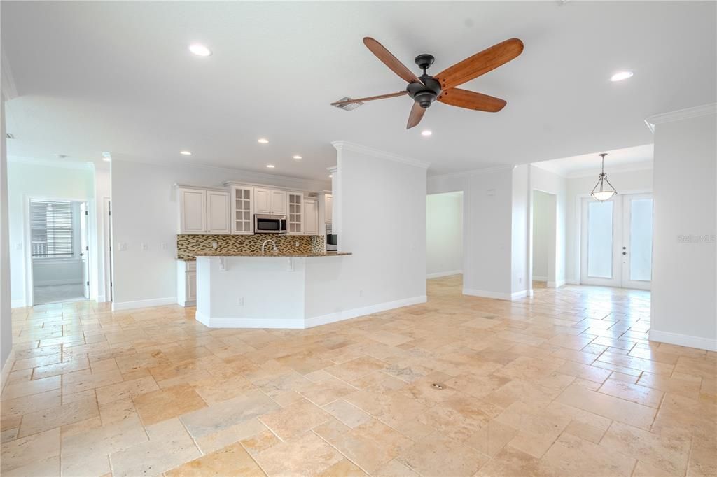 The open floor plan is perfect for entertaining and family gatherings, seamlessly connecting the living room with the kitchen, breakfast bar, and dinette area.