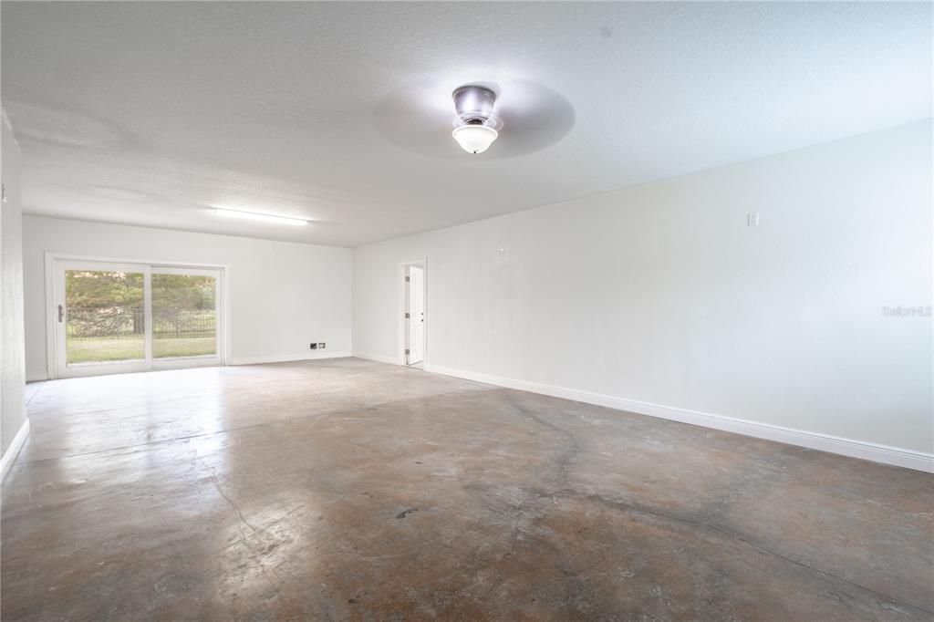 The ground floor 'bonus' room has hurricane impact sliding glass doors to the fenced in backyard.