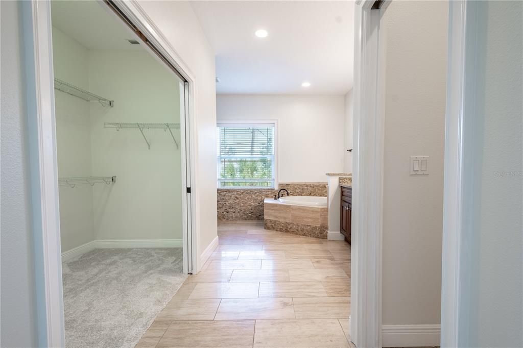 The primary bedroom has a spacious walk-in closet